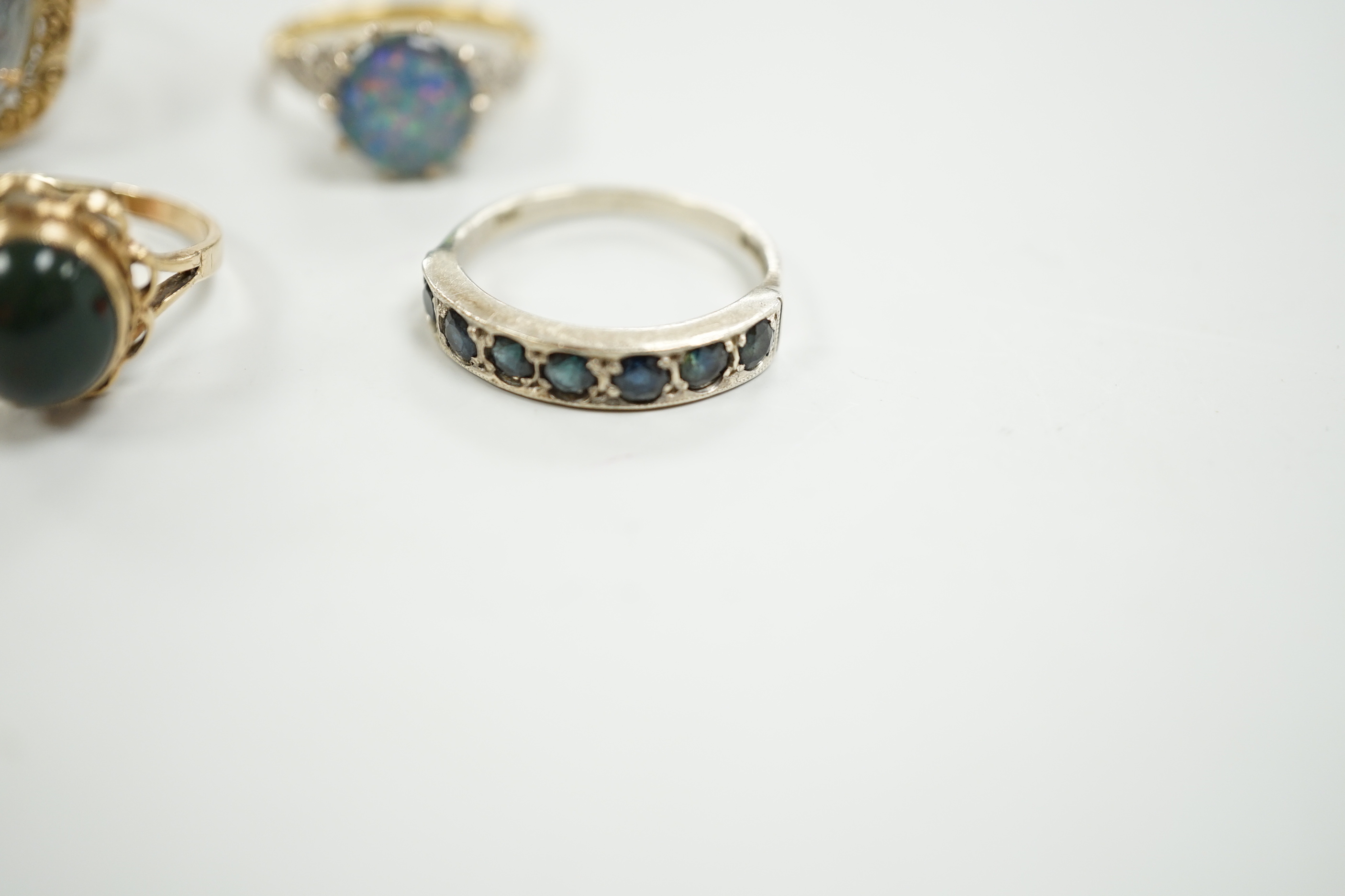 A 1940's 18ct and black opal doublet set dress ring, with diamond chip set shoulders, size L, a 14c and oval doublet ring and two other 9ct and gem set rings.